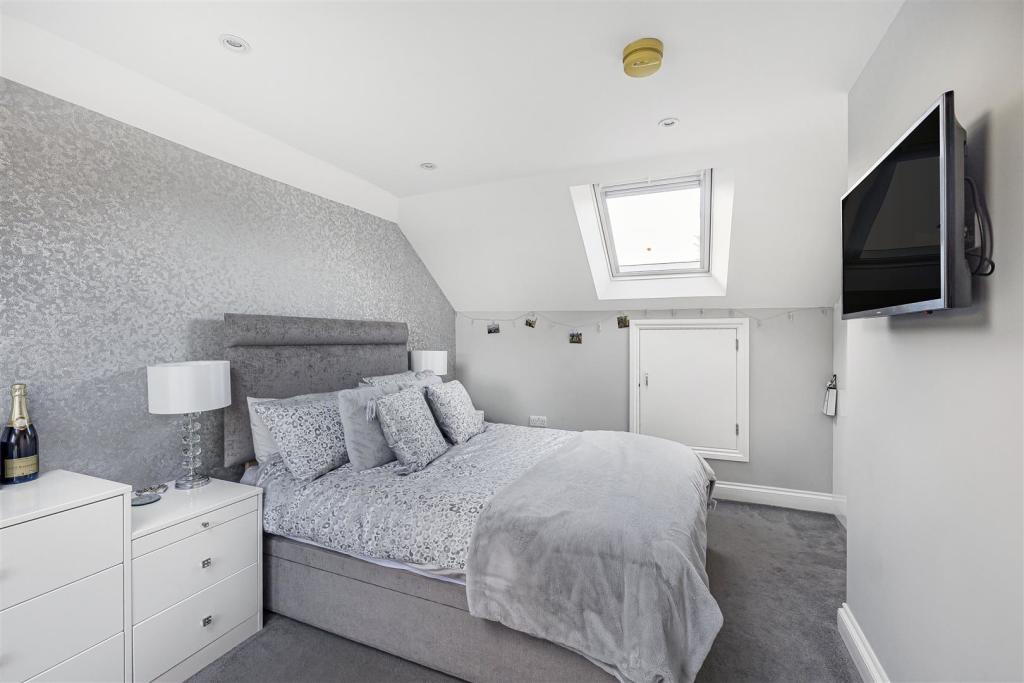 How does a loft conversion make the house in Willesden energy efficient?